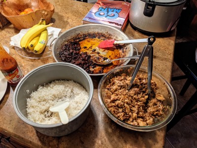 carnitas, black beans, steamed rice all stuffed inside of (unseen) burritos